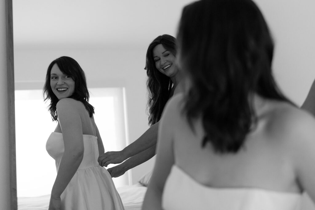 Bride being zipped up into wedding dress by Maid of Honor

Miami Destination Elopement Photographer