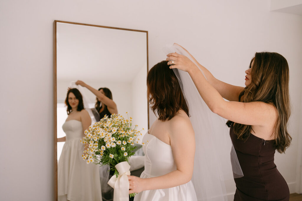 Bride being put wedding veil by Maid of Honor

Miami Destination Elopement Photographer