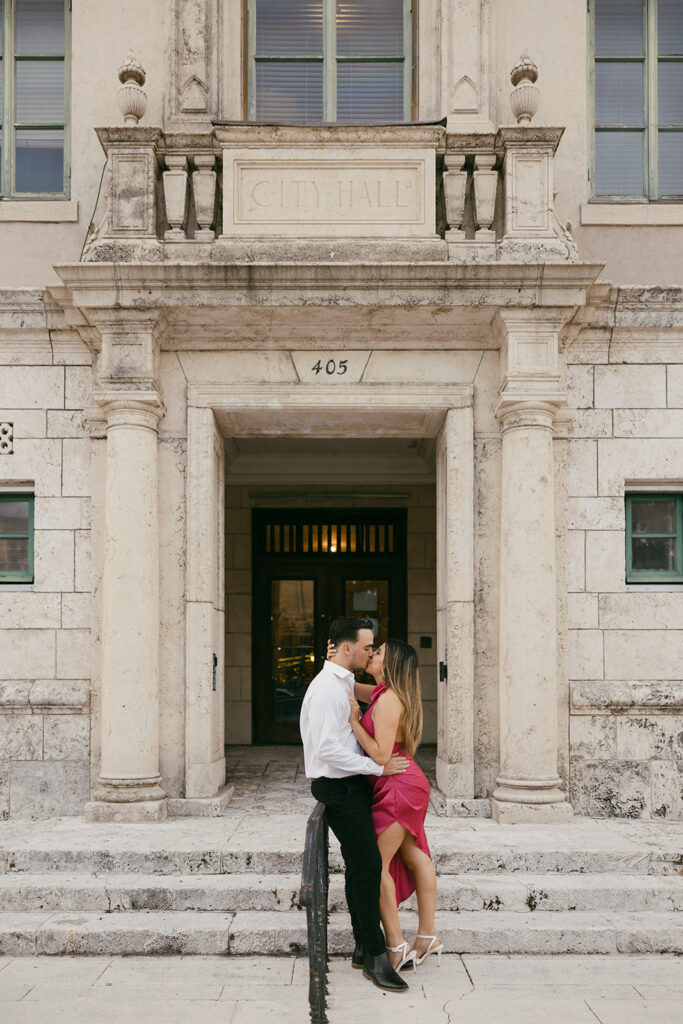 romantic courthouse engagement session kissing couple by staircases miami elopement photographer