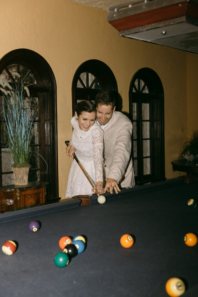 Elopement Pictures Spain Wedding Photographer playful pool table bride and groom pictures