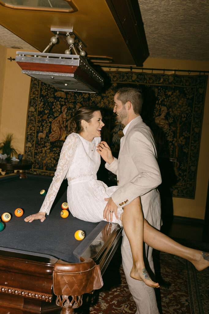 Elopement Pictures Spain Wedding Photographer playful pool table couple pictures