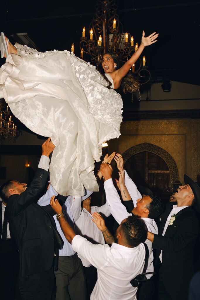 Texas Wedding Photographer Reception Bride Being Tossed in Air