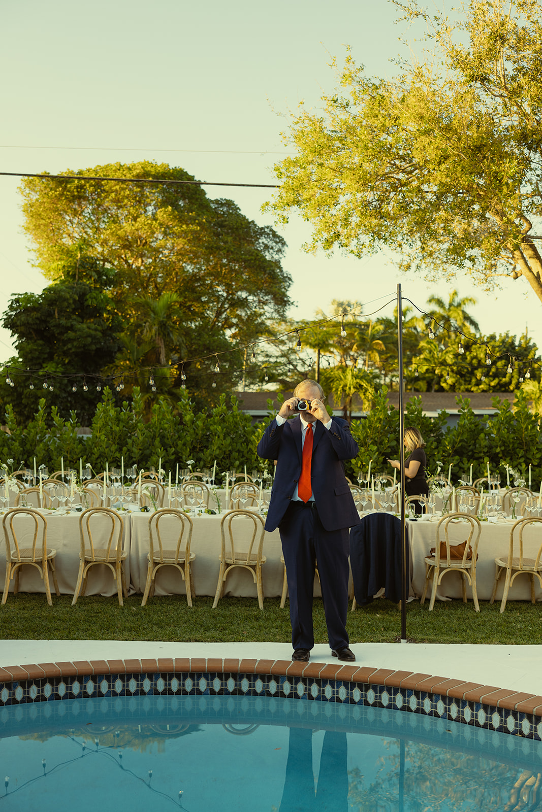 documentary guest taking film during cocktail hour dreamy and elevated intimate backyard wedding by Aileen Ayala Photography