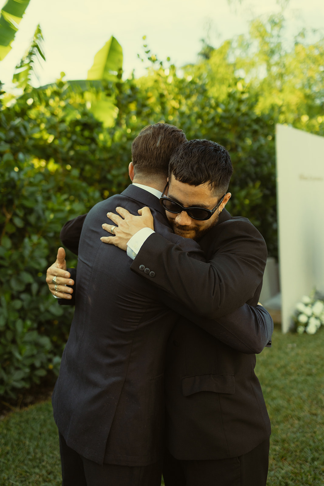 documentary guests hugging groom cocktail hour dreamy and elevated intimate backyard wedding by Aileen Ayala Photography