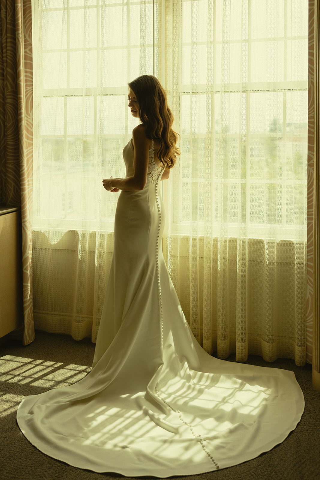 The Don CeSar Wedding Bride Getting Ready Anthropology Wedding Dress Bridal Portrait By Window Harsh Lighting No Veil