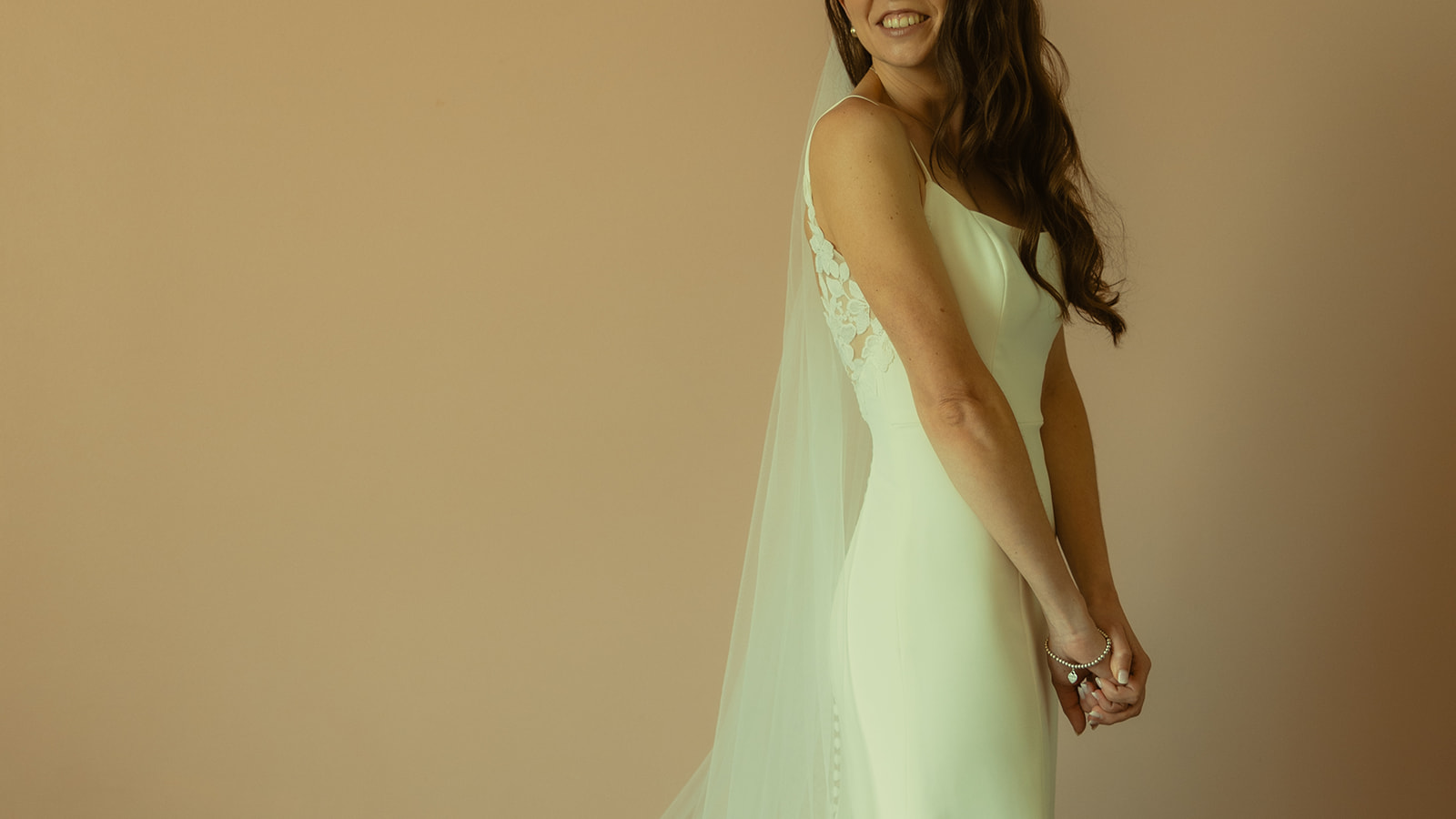 The Don CeSar Wedding Bride Getting Ready Anthropology Wedding Dress Bridal Portrait Portrait of Dress, Veil, and smiling bride