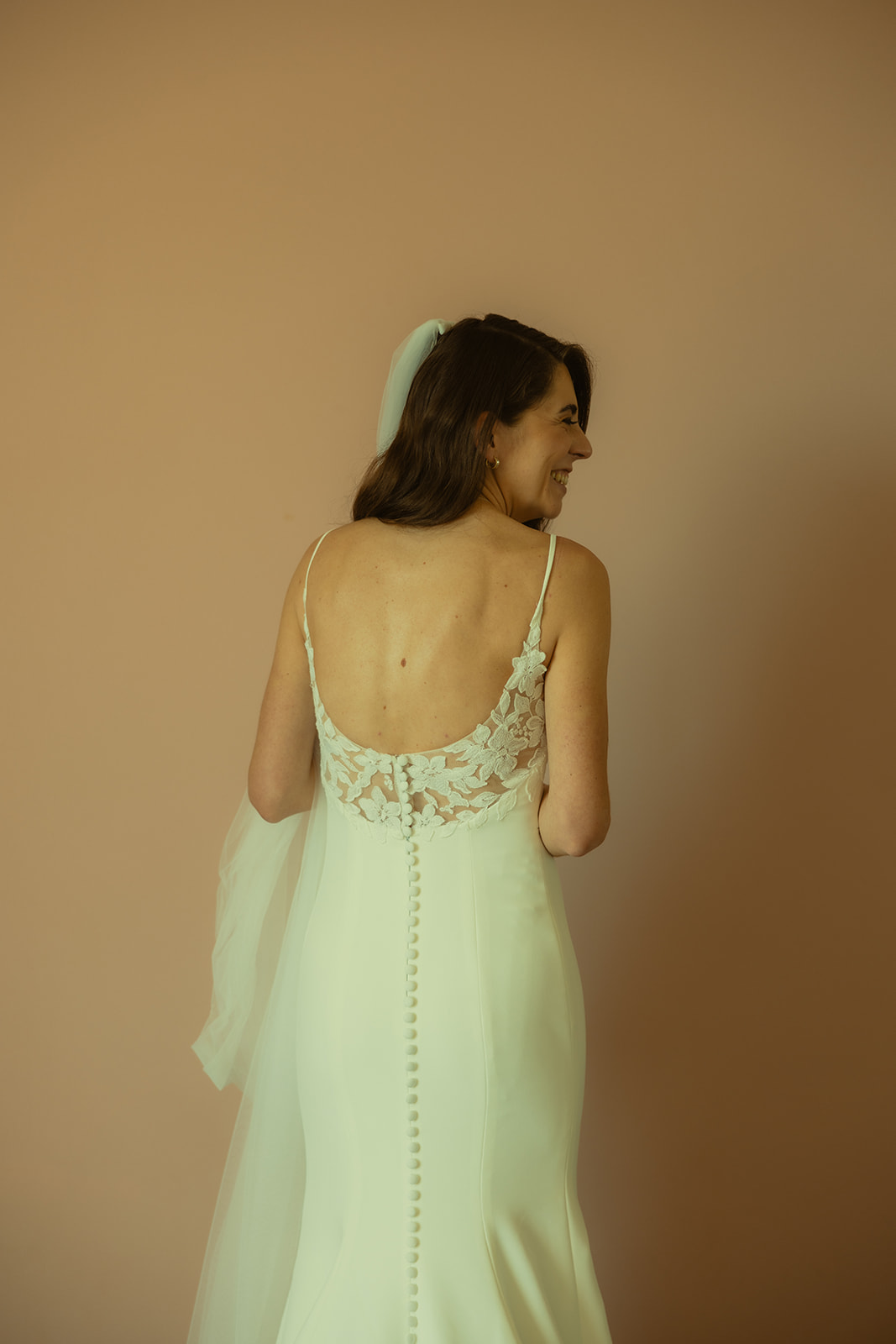 The Don CeSar Wedding Bride Getting Ready Anthropology Wedding Dress Up Close Bridal Portrait Lace Floral Back Detail Laughing Bride