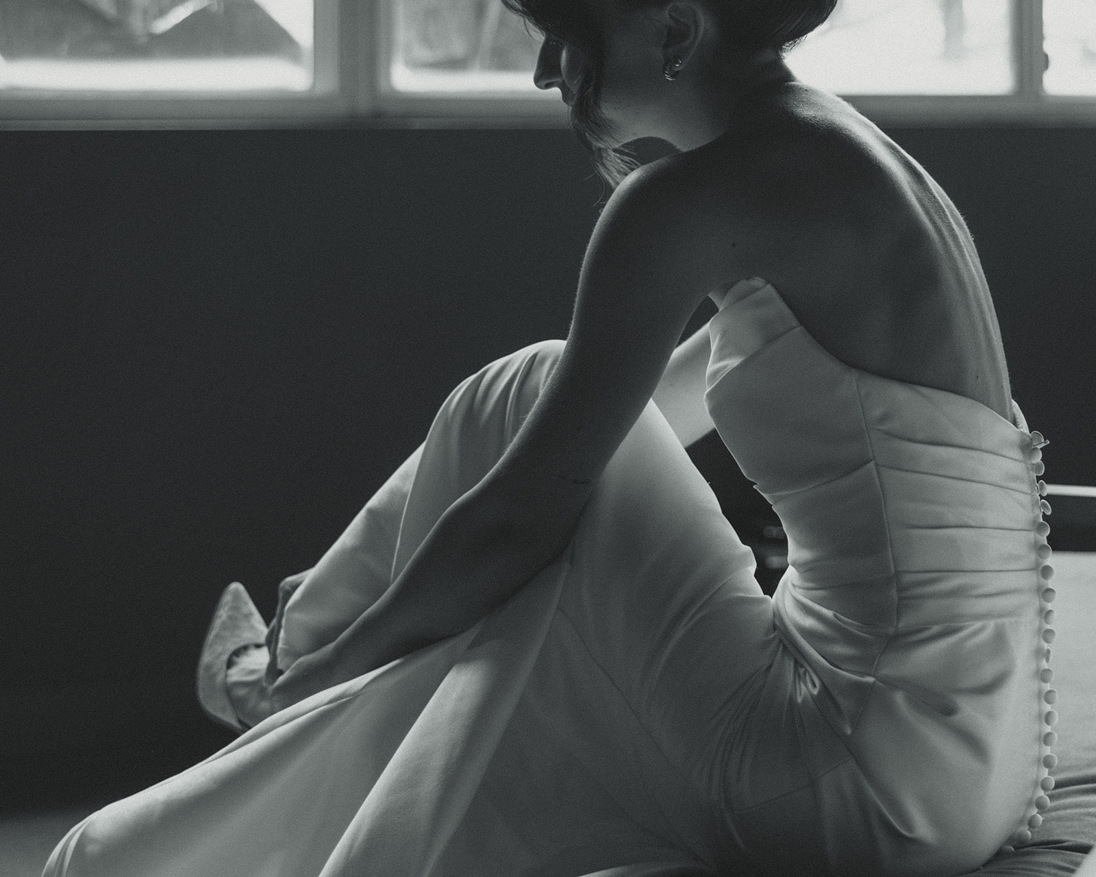 Black and White Bride Putting Wedding Heels Timeless Wedding in Mayfair Hotel & Garden