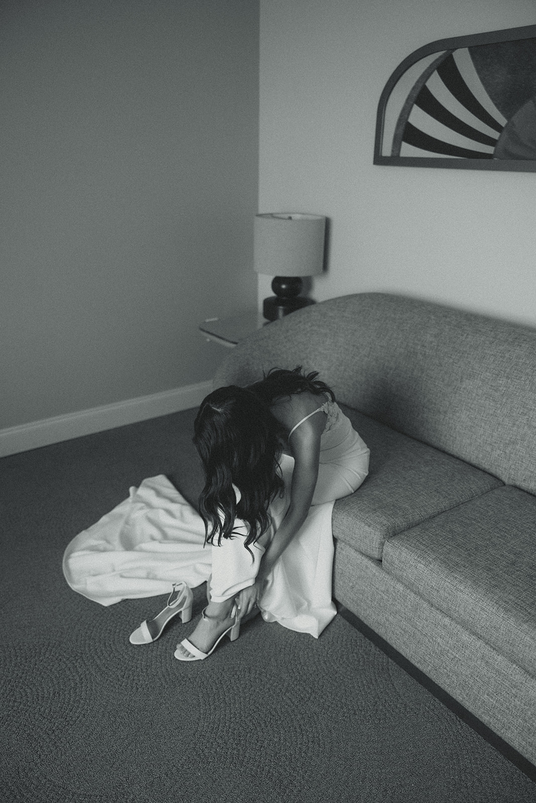 The Don CeSar Wedding Bride Getting Ready Putting Wedding Heels On Anthropology Wedding Dress Black and White