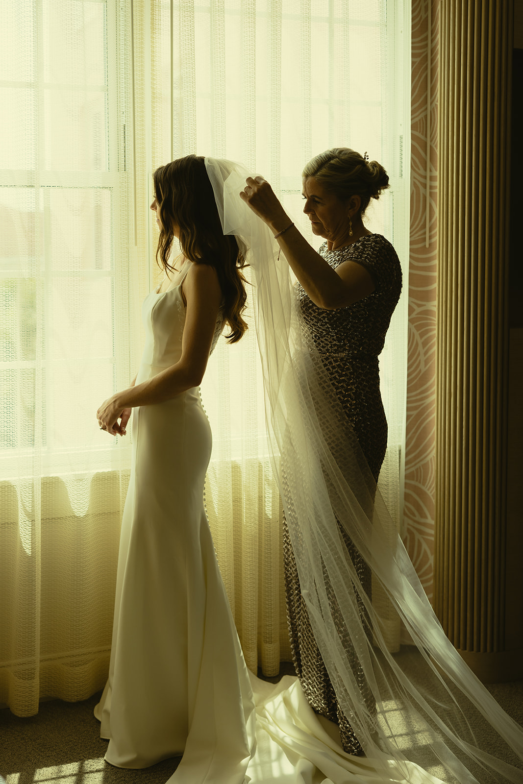 The Don CeSar Wedding Bride Getting Ready Anthropology Wedding Dress Mom putting Veil