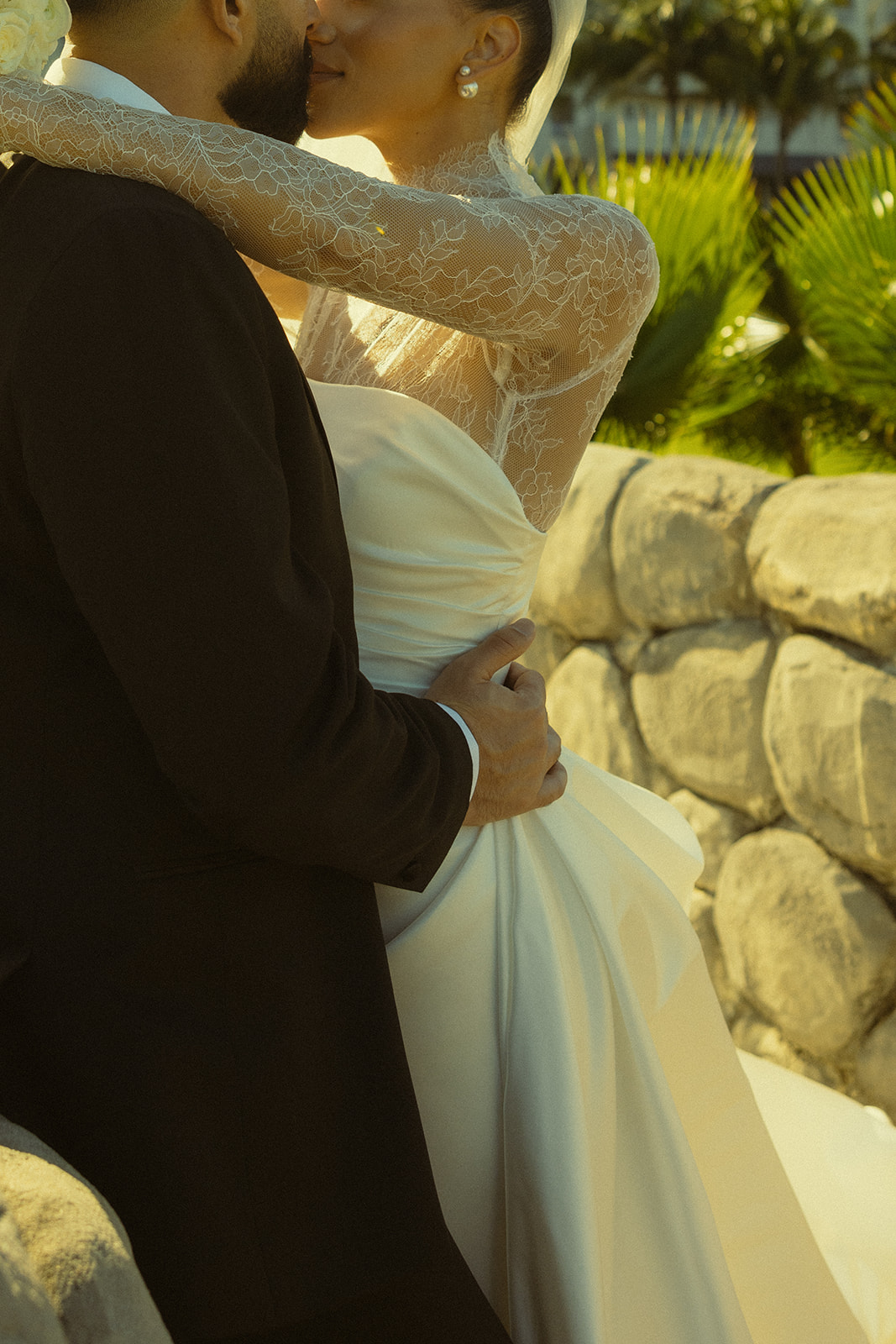 Bride and Groom Kissing in JW Marriott Turnberry in Miami Florida. Documentary Wedding Photographer. Essense of Australia Wedding Dress. Mesh Turtle Neck.