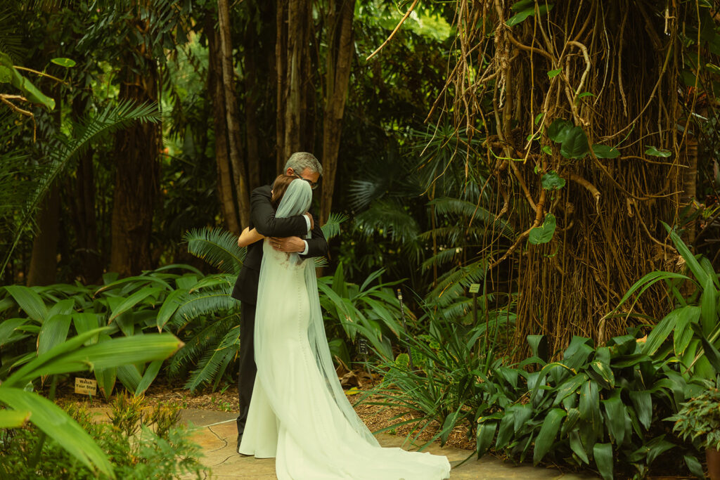 Bride & Father First Look for Wedding in Sunken Gardens in St.Petersburg. Bride and Dad hugging