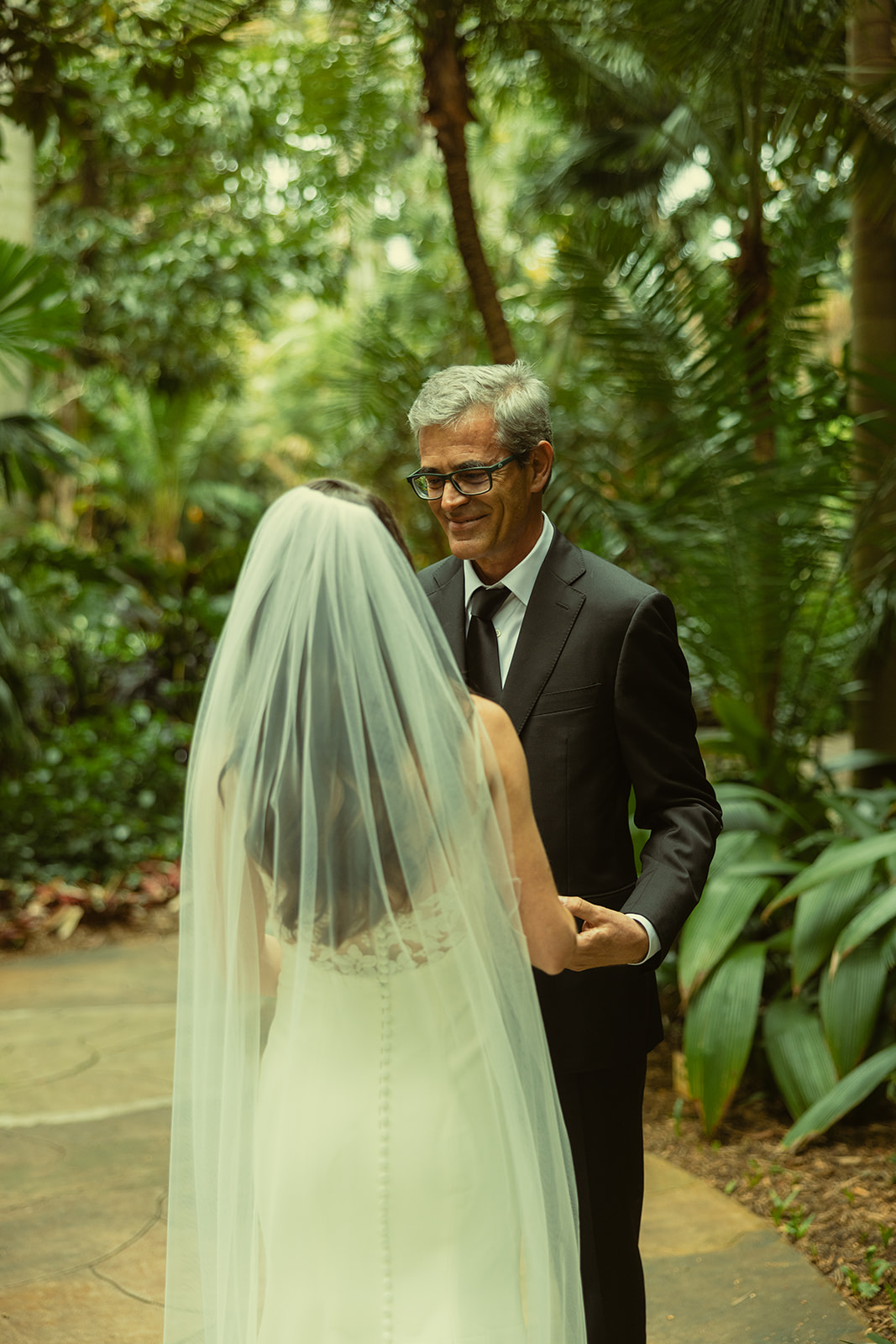 Bride & Father First Look for Wedding in Sunken Gardens in St.Petersburg. Dad smiling at daughter.