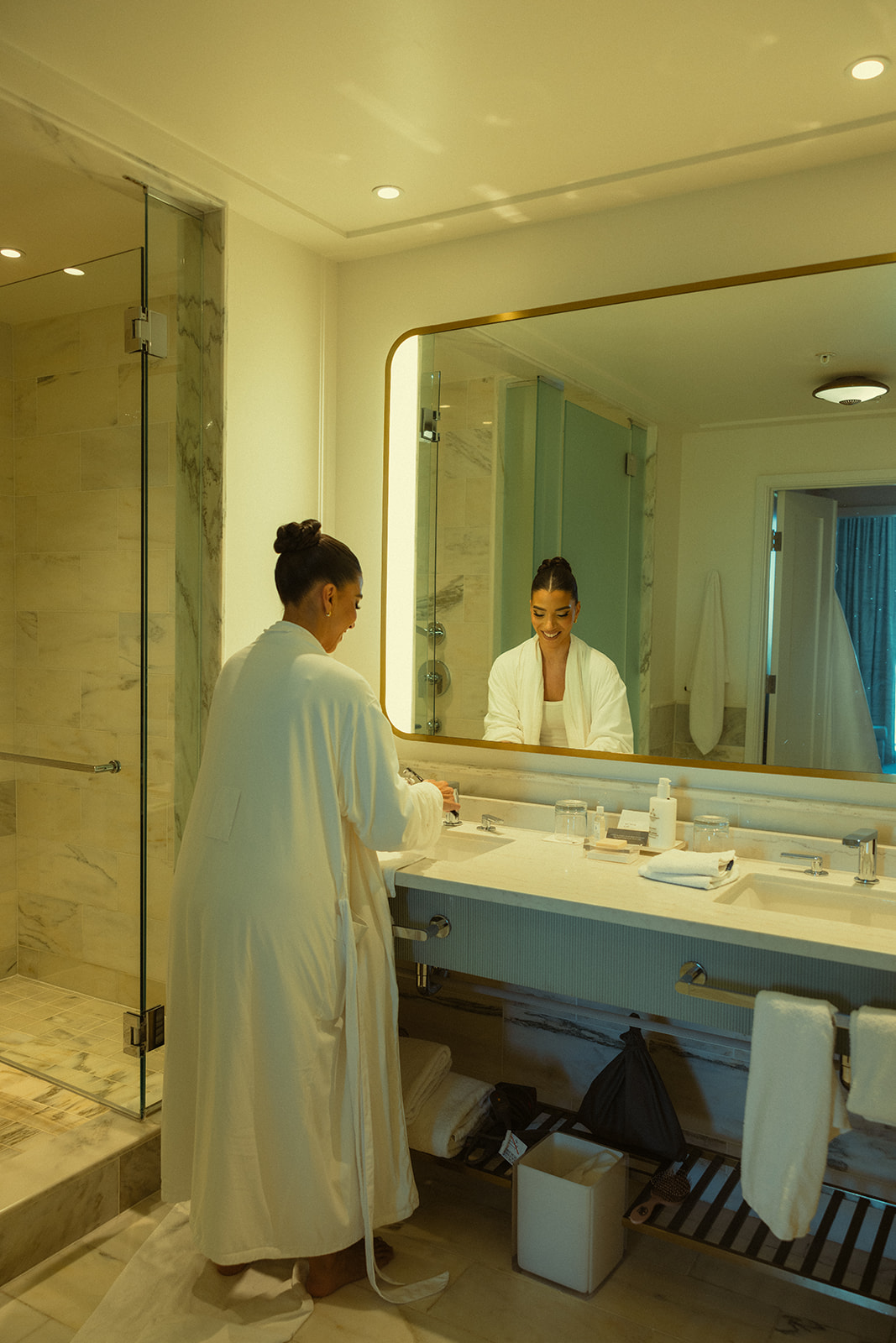 Bride Smiling in Robe Getting Ready in Suite for Wedding at JW Miami Turnberry Resort & Spa in Aventura, Florida