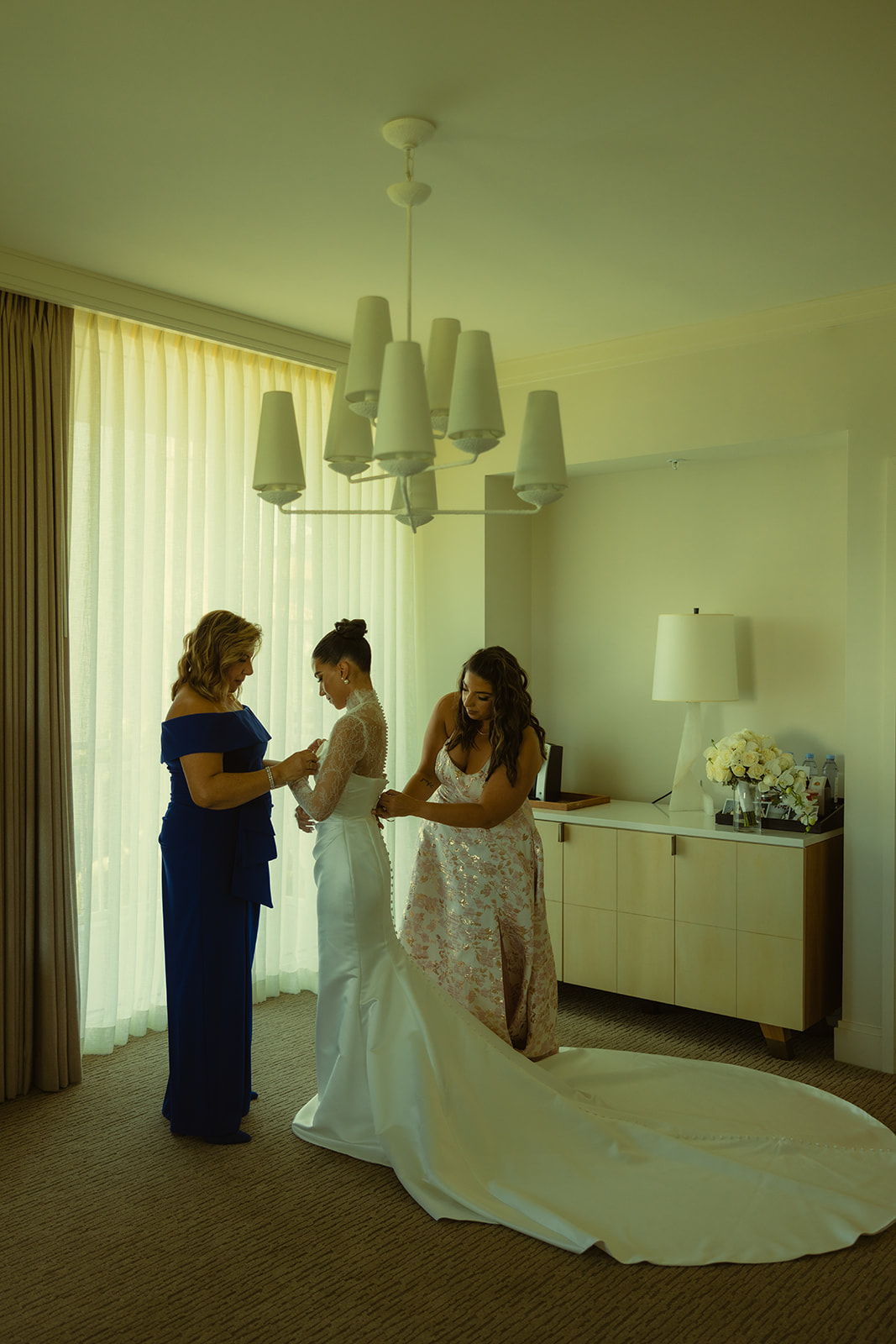 Brides Wedding Dress Zip Up with Sister and Mom JW Miami Turnberry Resort & Spa in her Essense of Australia Wedding Dress Wide Shot