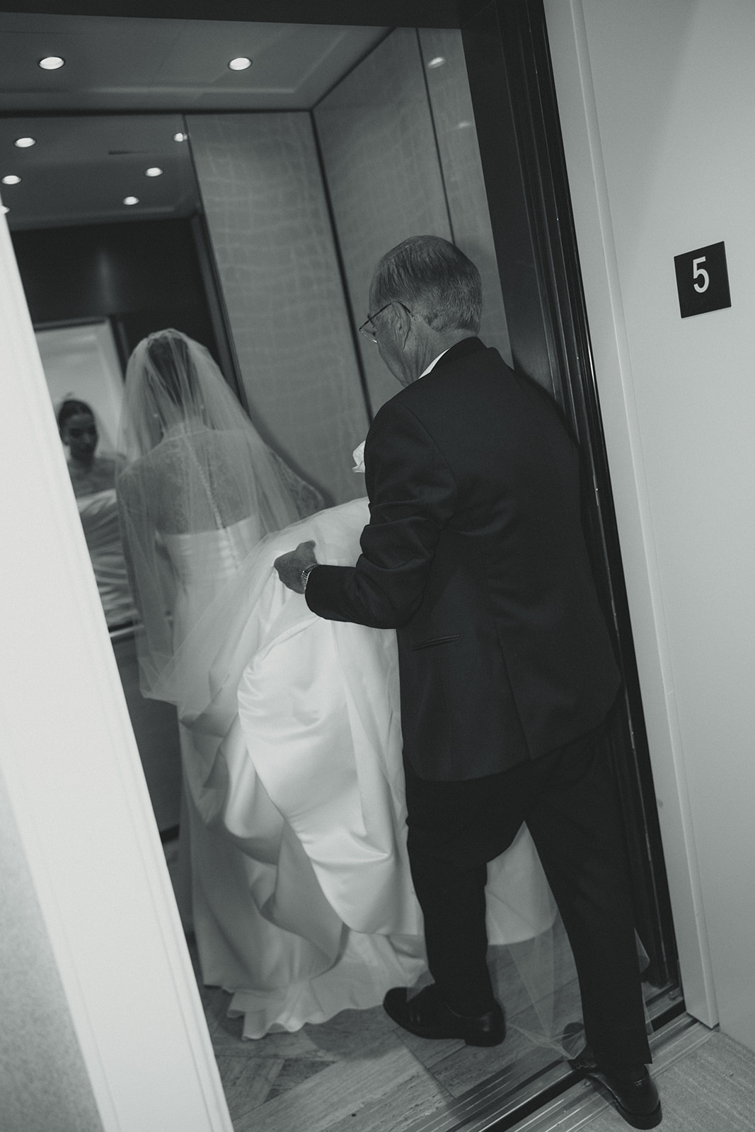 Bride and Father of Bride Helping Bride with wedding dress into elevator JW Marriot Turnberry Wedding