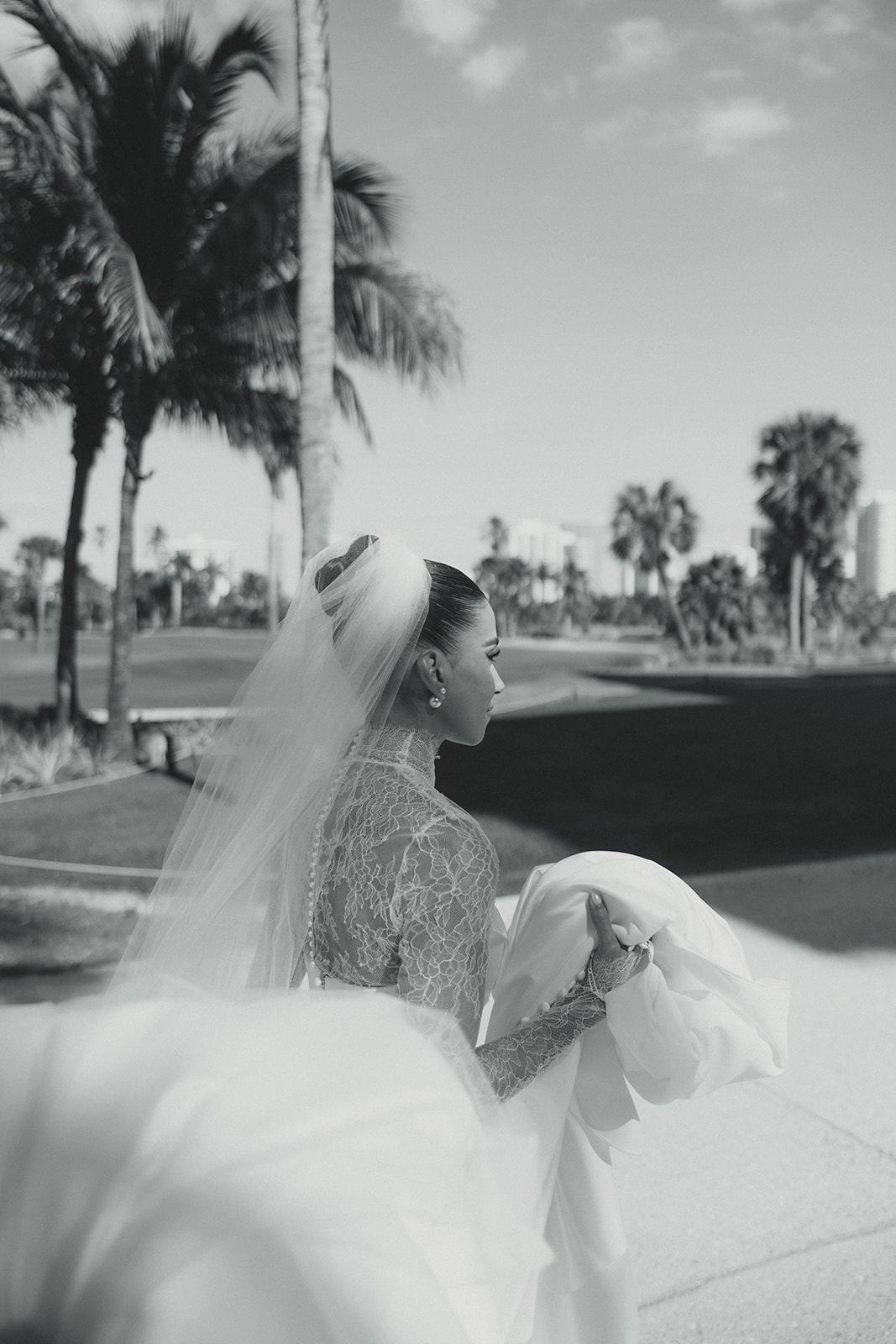 Candid Bride Holding her Wedding Dress & Veil at the JW Turnberry Resort in Aventura Florida 