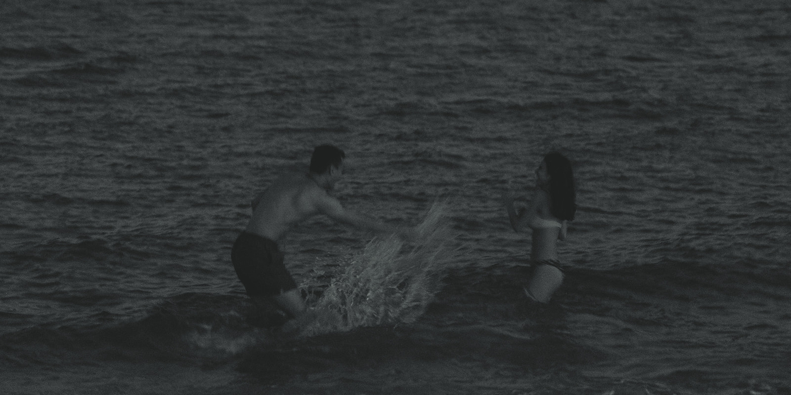 Couple Splashing Water Candid in Water Couples Engagement Session In Miami Beach 