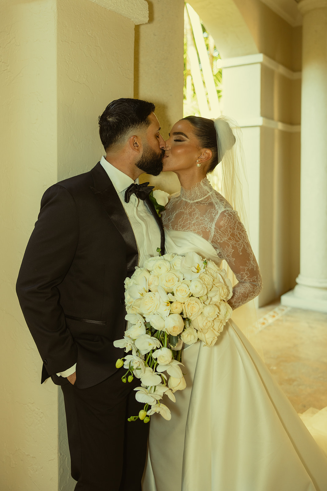 Bride and Groom Kissing Wedding Portraits. White Roses & Orchids Bouquet. JW Marriott Turnberry in Miami Florida.