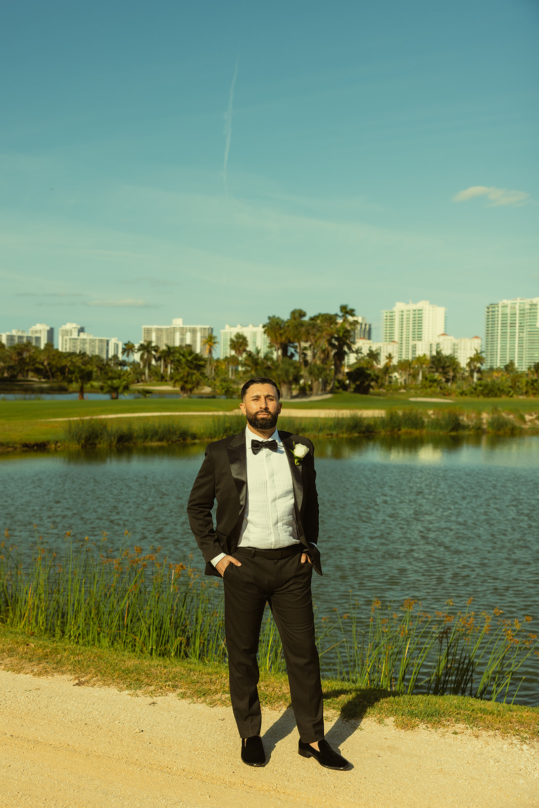 Editorial Groom Portraits in JW Marriott Turnberry in Aventura Golf Course with Miami Skyline. 