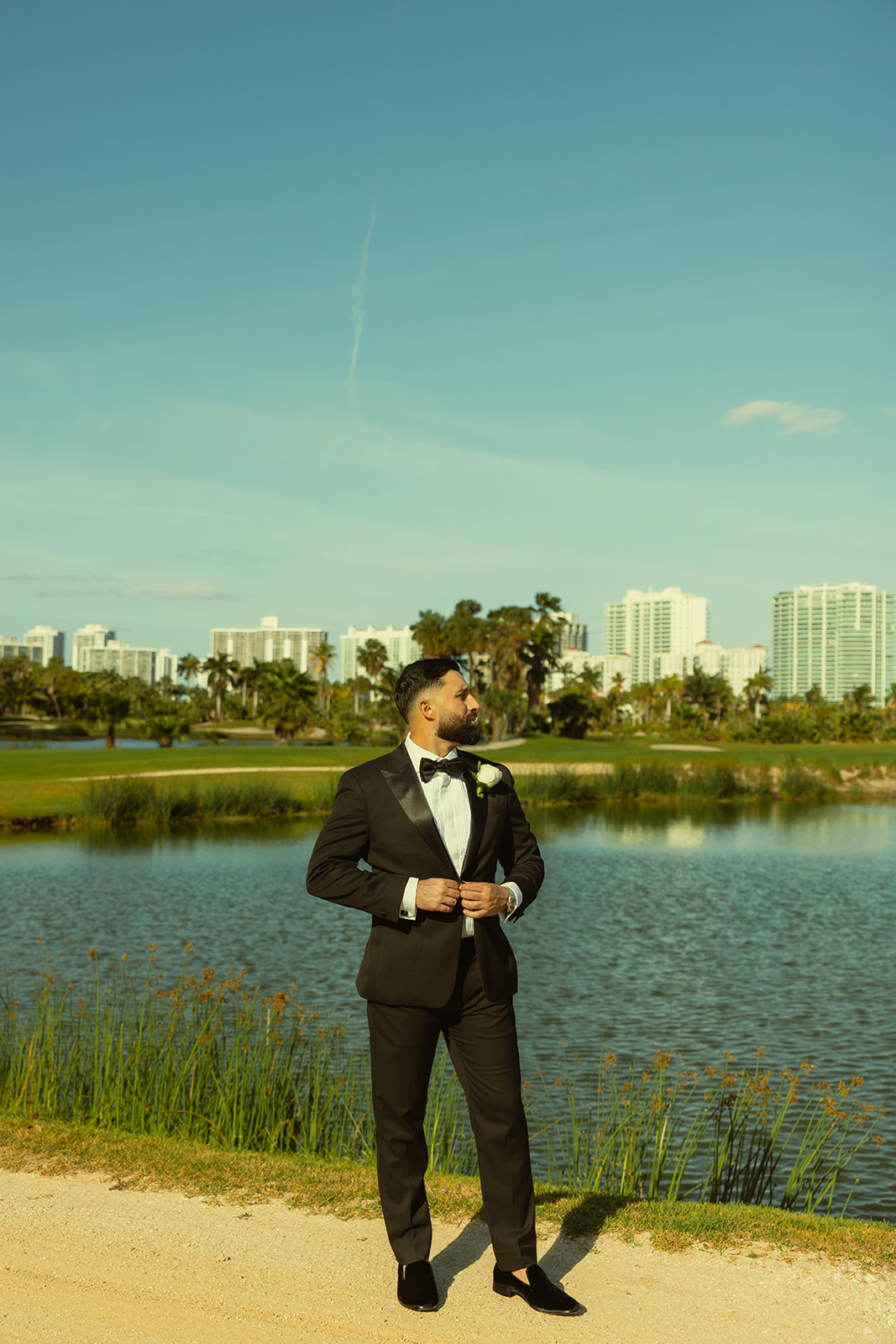 Editorial And Elegant Groom Portraits in JW Marriott Turnberry in Aventura Golf Course with Miami Skyline. 