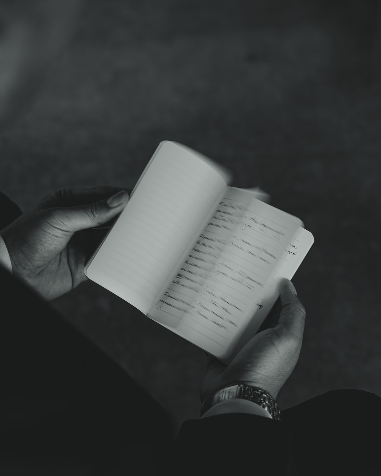 Groom Flipping Through Vow Book Artsy Wedding in Mayfair Hotel & Garden Black and White