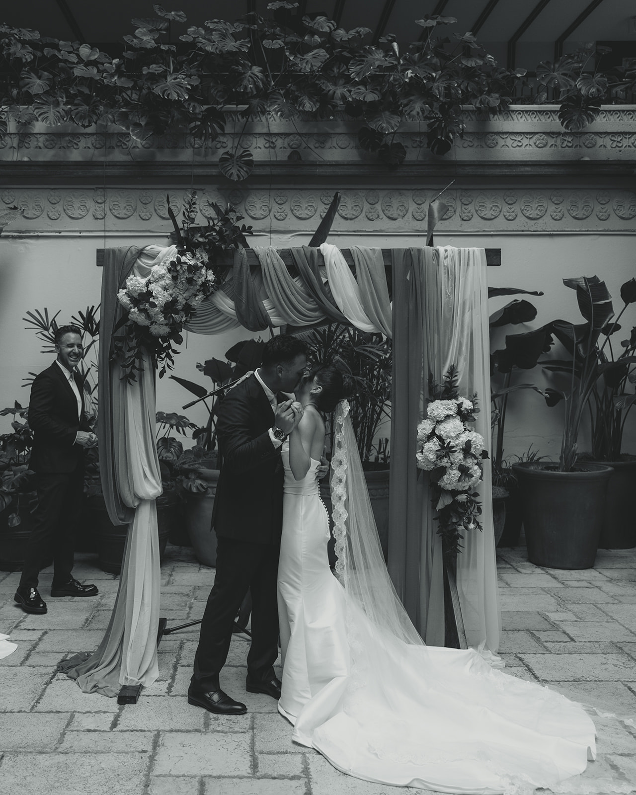 Wedding ceremony Bride and Groom First Kiss as Newly Weds Timeless Wedding in Mayfair Hotel & Garden Black and White