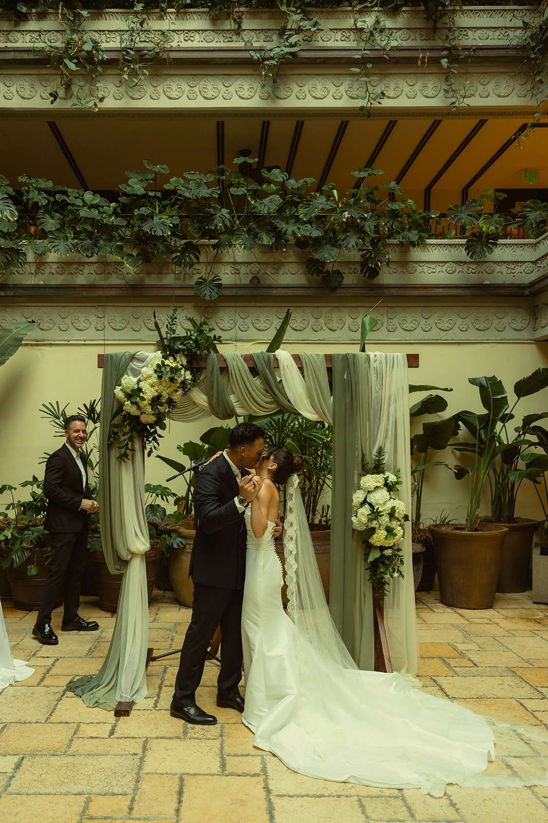 Wedding ceremony Bride and Groom First Kiss as Newly Weds Timeless Wedding in Mayfair Hotel & Garden