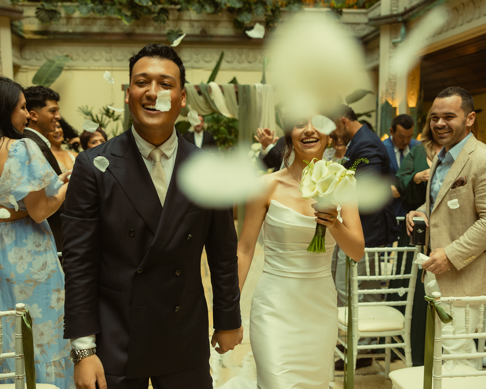 Wedding ceremony Bride and Groom Exiting Ceremony as Newly Weds with White Rose Pedals being Thrown Timeless Wedding in Mayfair Hotel & Garden