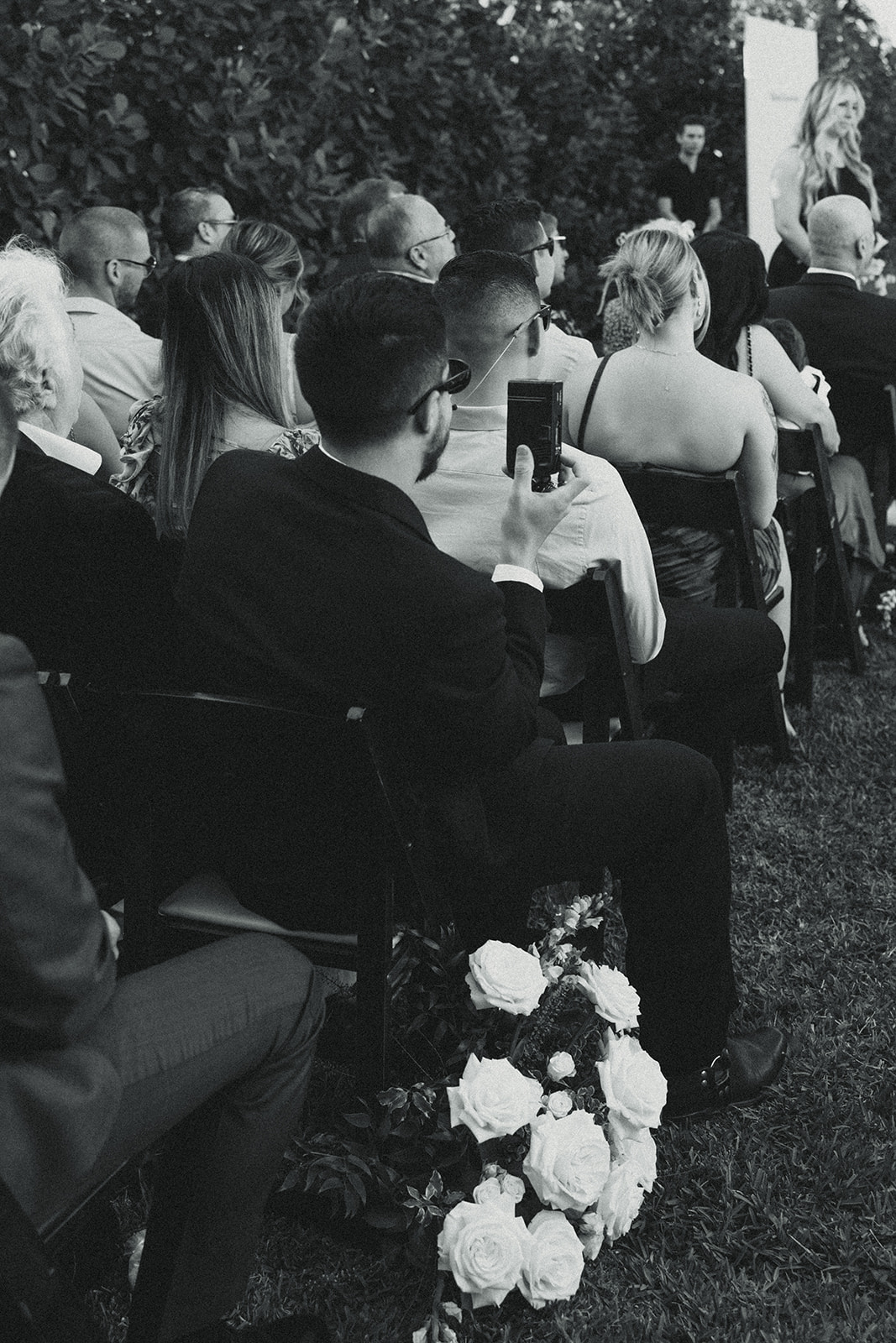 guests documenting film during wedding ceremony dreamy and elevated intimate backyard wedding by Aileen Ayala Photography black and white