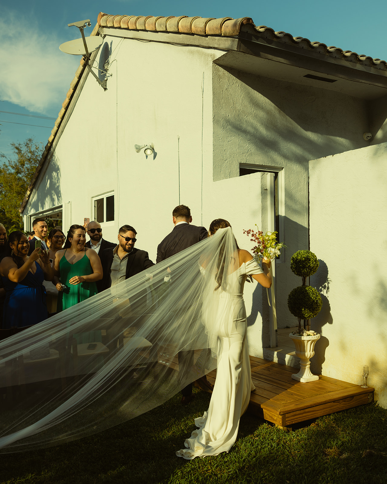 Newly Weds exiting wedding ceremony Sarah Seven NYC Veil dreamy and elevated intimate backyard wedding by Aileen Ayala Photography