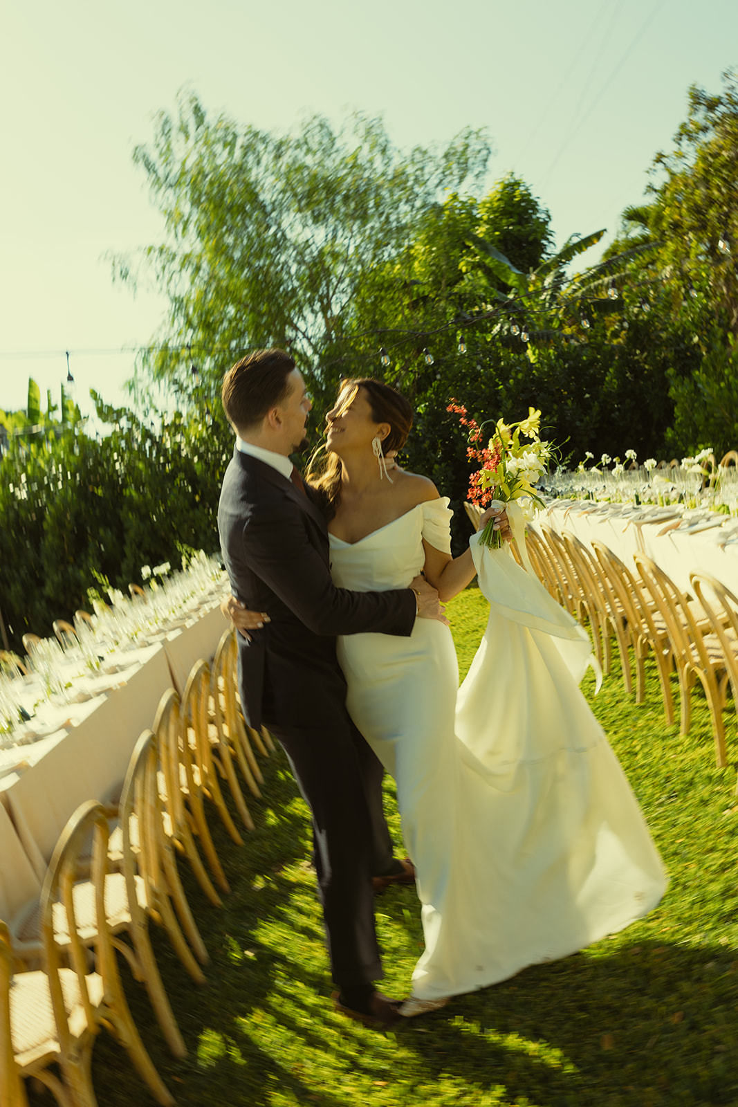 laughing and walking Bride & Groom couple portraits dreamy and elevated intimate backyard wedding by Aileen Ayala Photography motion blur