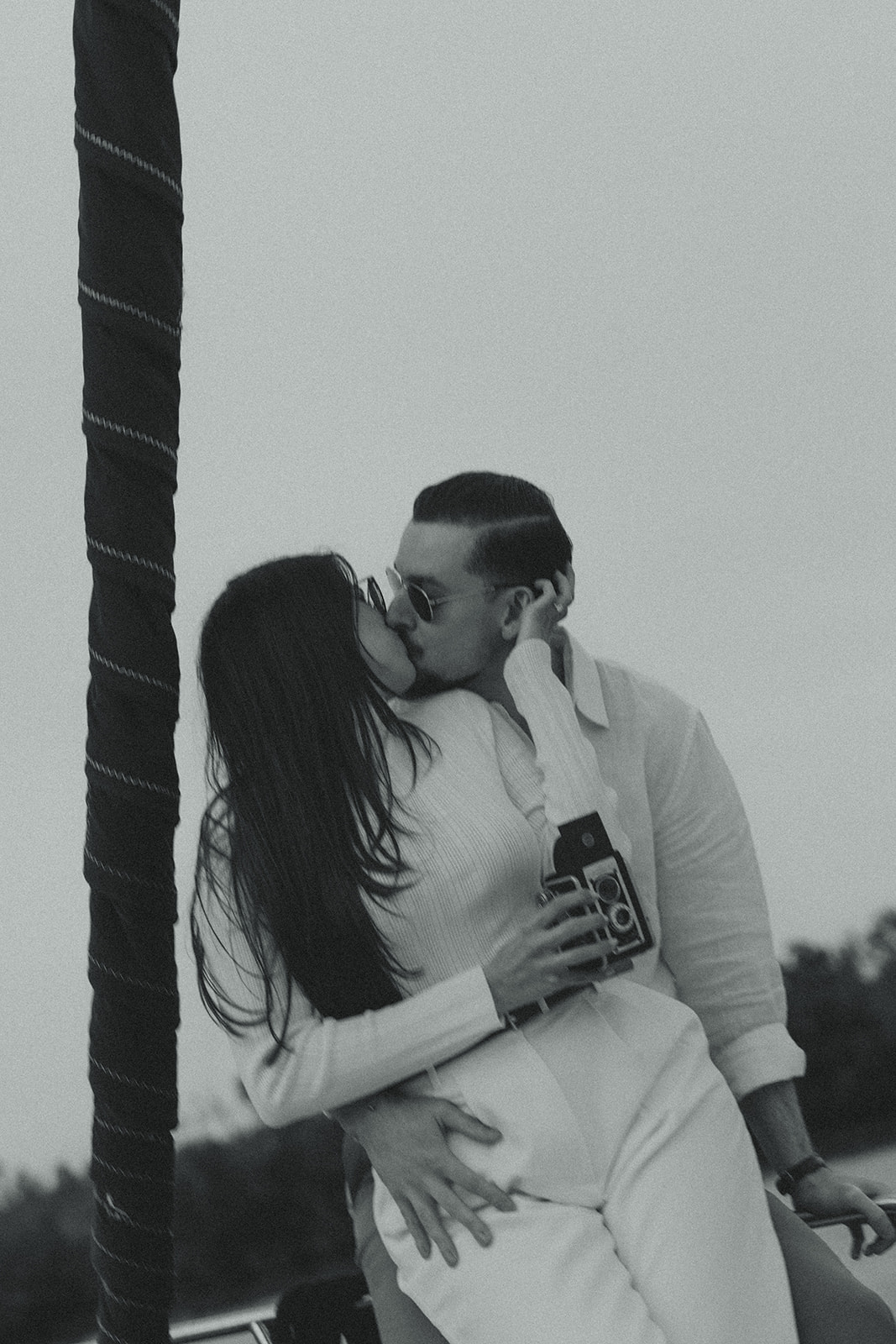 Sailboat Engagement NYC Harbor with Super 8 Kissing Couple