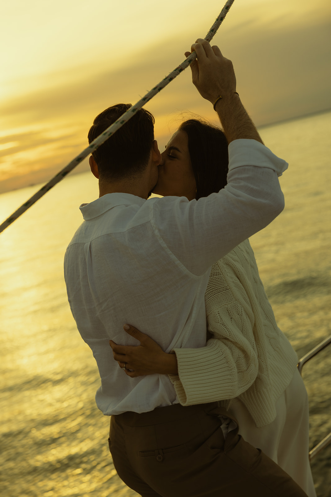 Sailboat Engagement Session in Miami, Holding Sailboat Lines and Couple Kissing