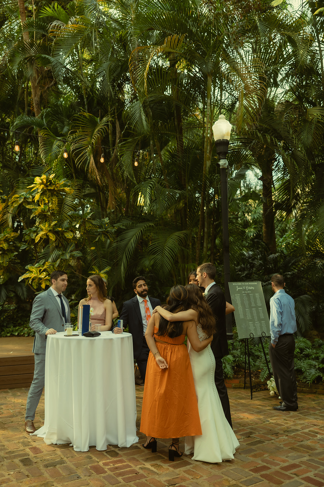 Sunken Garden Wedding Cocktail Hour Guest Documentary Wedding Photographer in St.Petersburg Guests hugging bride and groom