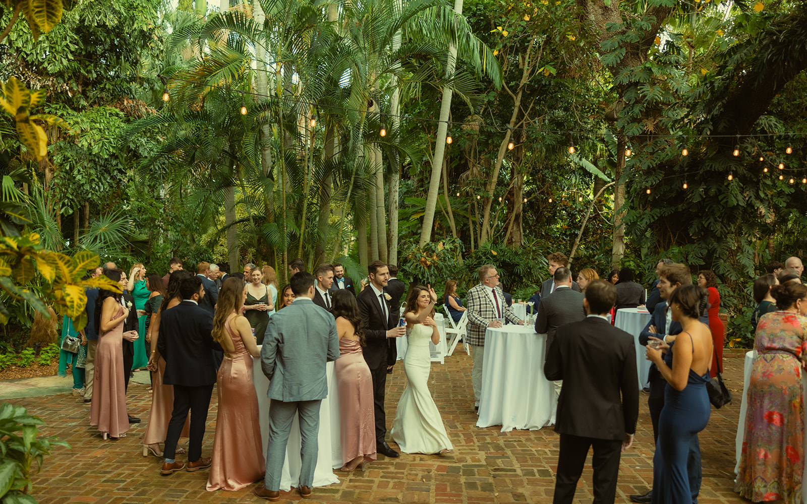 Sunken Garden Wedding Cocktail Hour Guest Documentary Wedding Photographer in St.Petersburg Bride and Groom waving