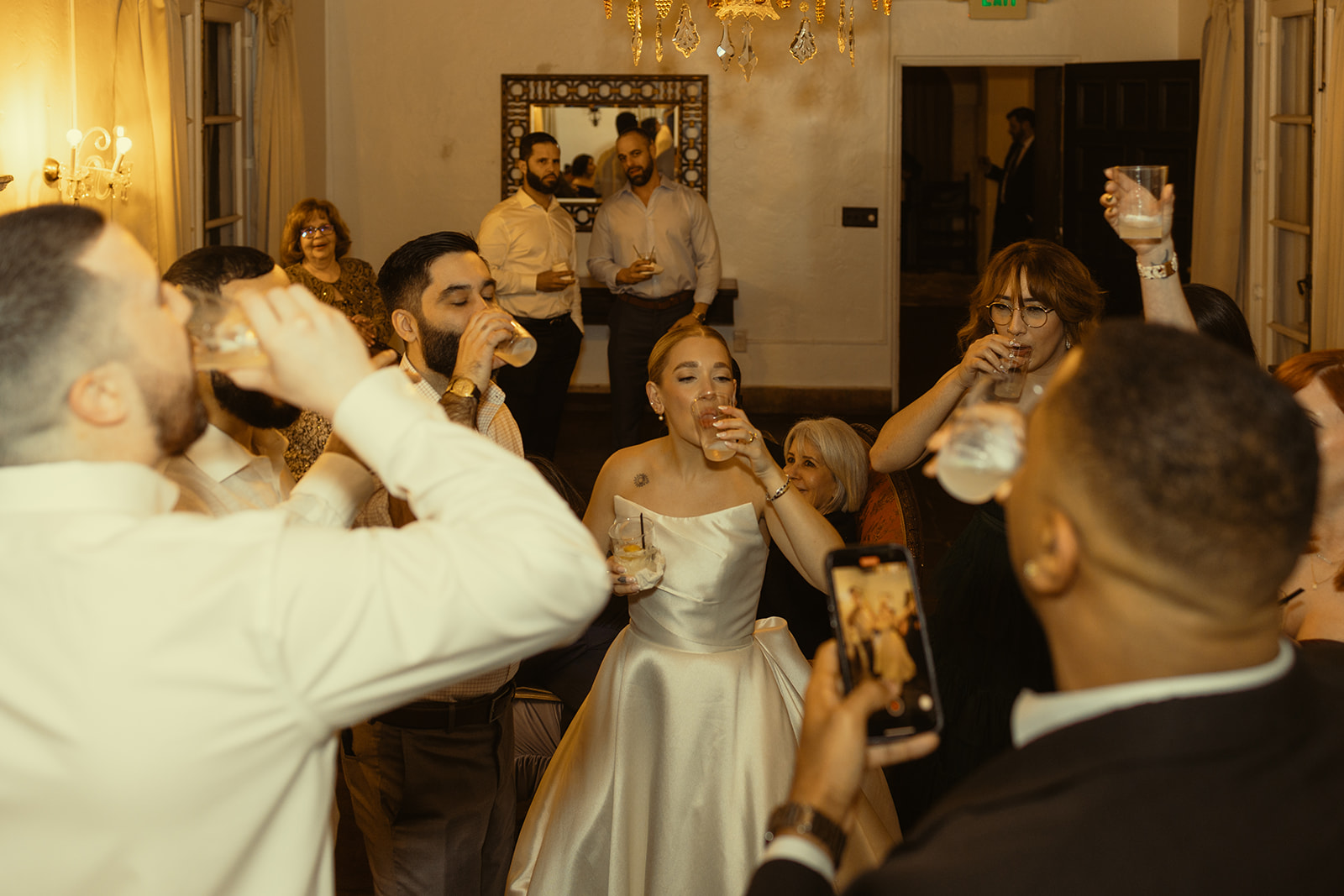 Candid Bride & Guests Taking Shot Wedding Reception Villa Woodbine Tuscany-Inspired Venue in Miami Florida