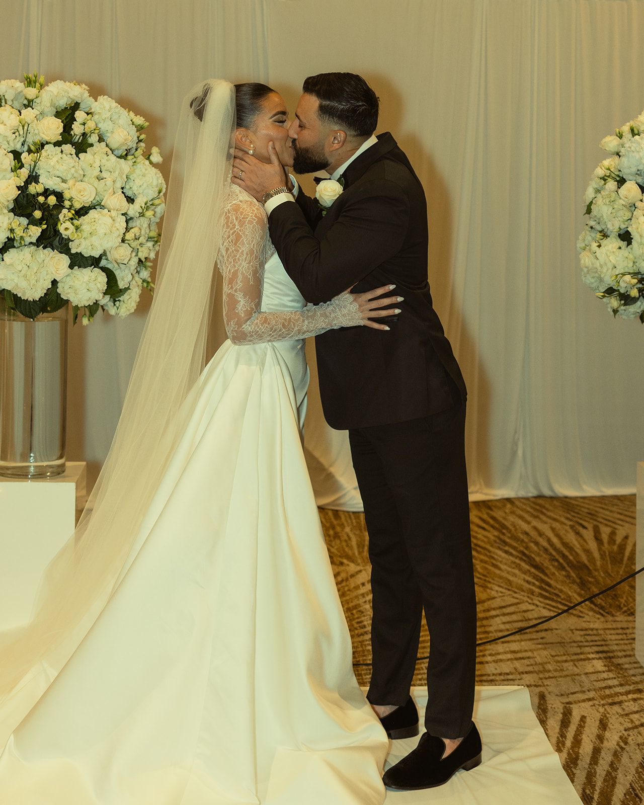 Newly Weds First Kiss at wedding ceremony at JW Miami Turnberry. Ballroom Wedding Ceremony