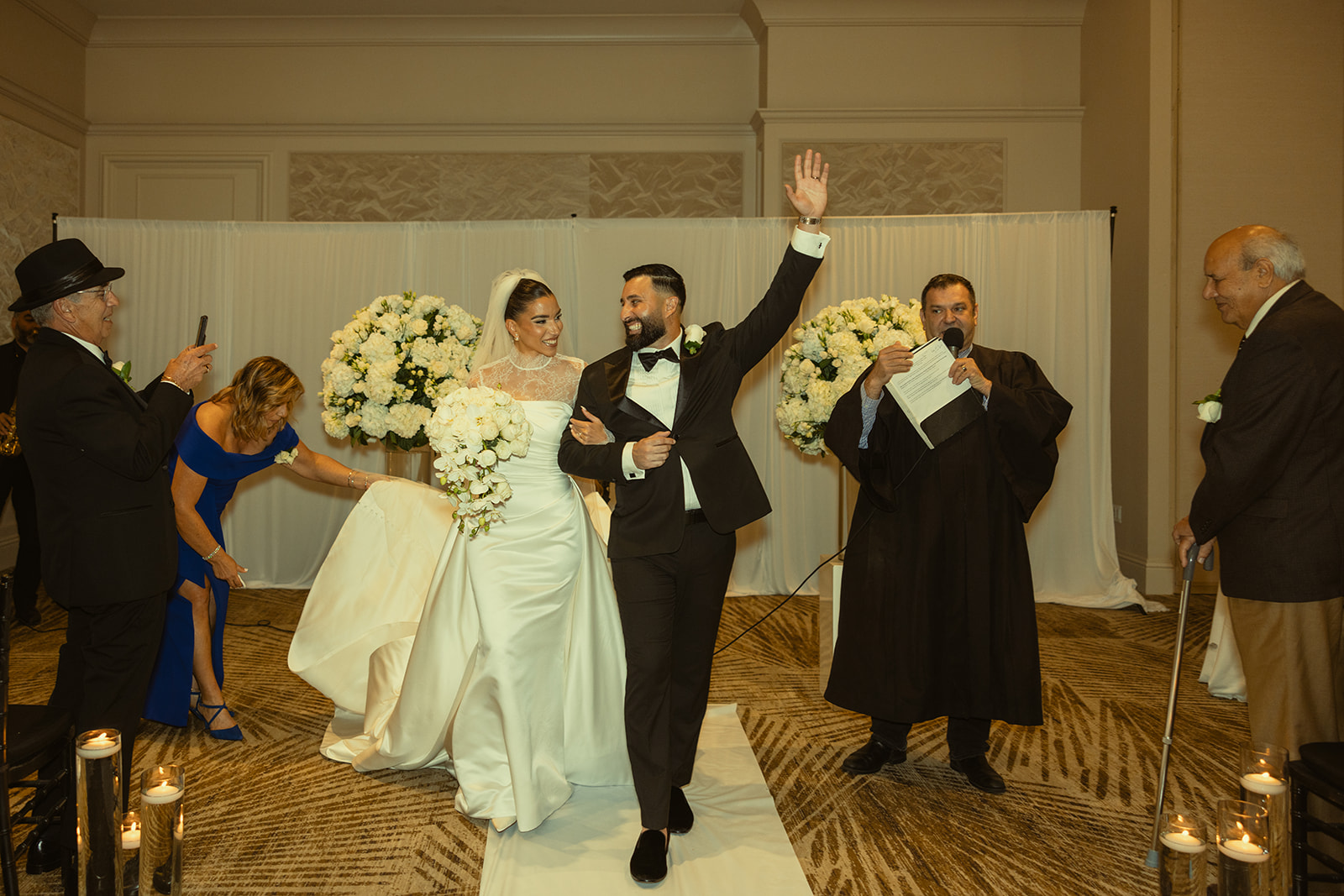 Bride and Groom Exiting as Newly Weds down wedding ceremony aisle at JW Miami Turnberry. Ballroom Wedding Ceremony