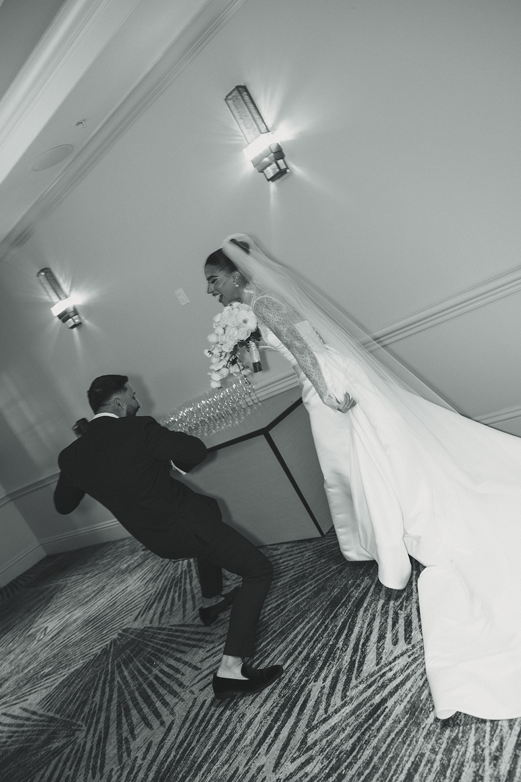 Bride and Groom Candid of them Dancing Cheering Laughing After Wedding Ceremony at JW Miami Turnberry. Ballroom Wedding Ceremony in Black and White