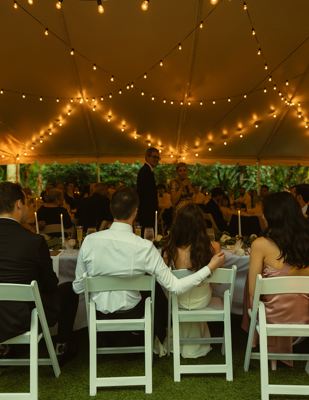 Bride and Groom candid during speeches in reception. Wedding in Central Florida