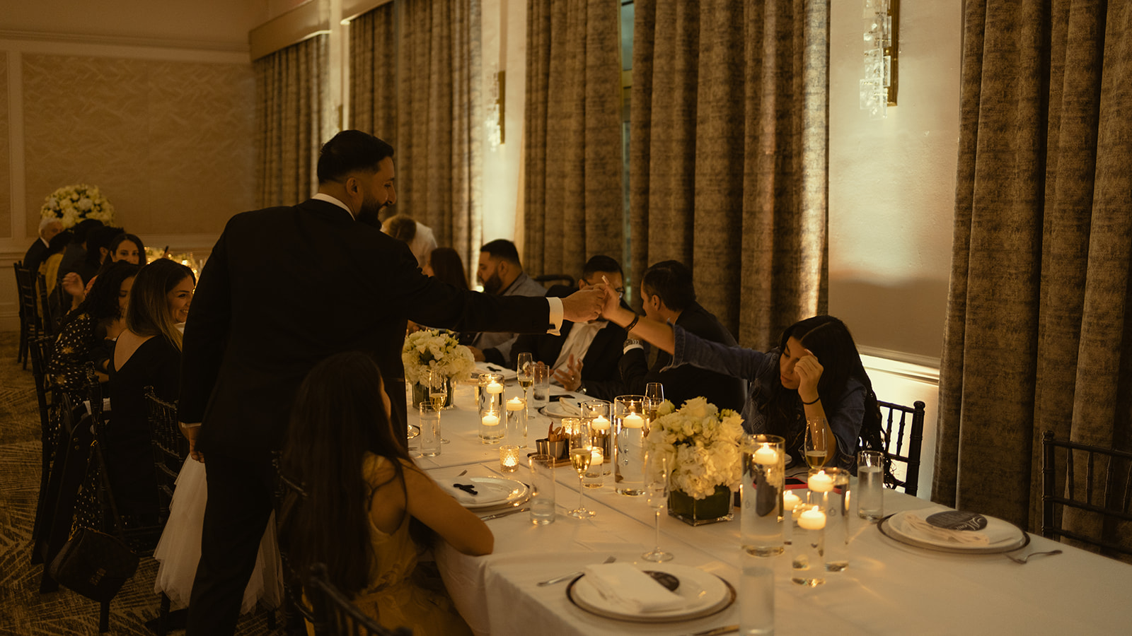 Bride and Groom Dinner Candids Marriott Turnberry in Miami Aventura Florida. White Roses. Elegant and simple Tables cape and big floral arrange