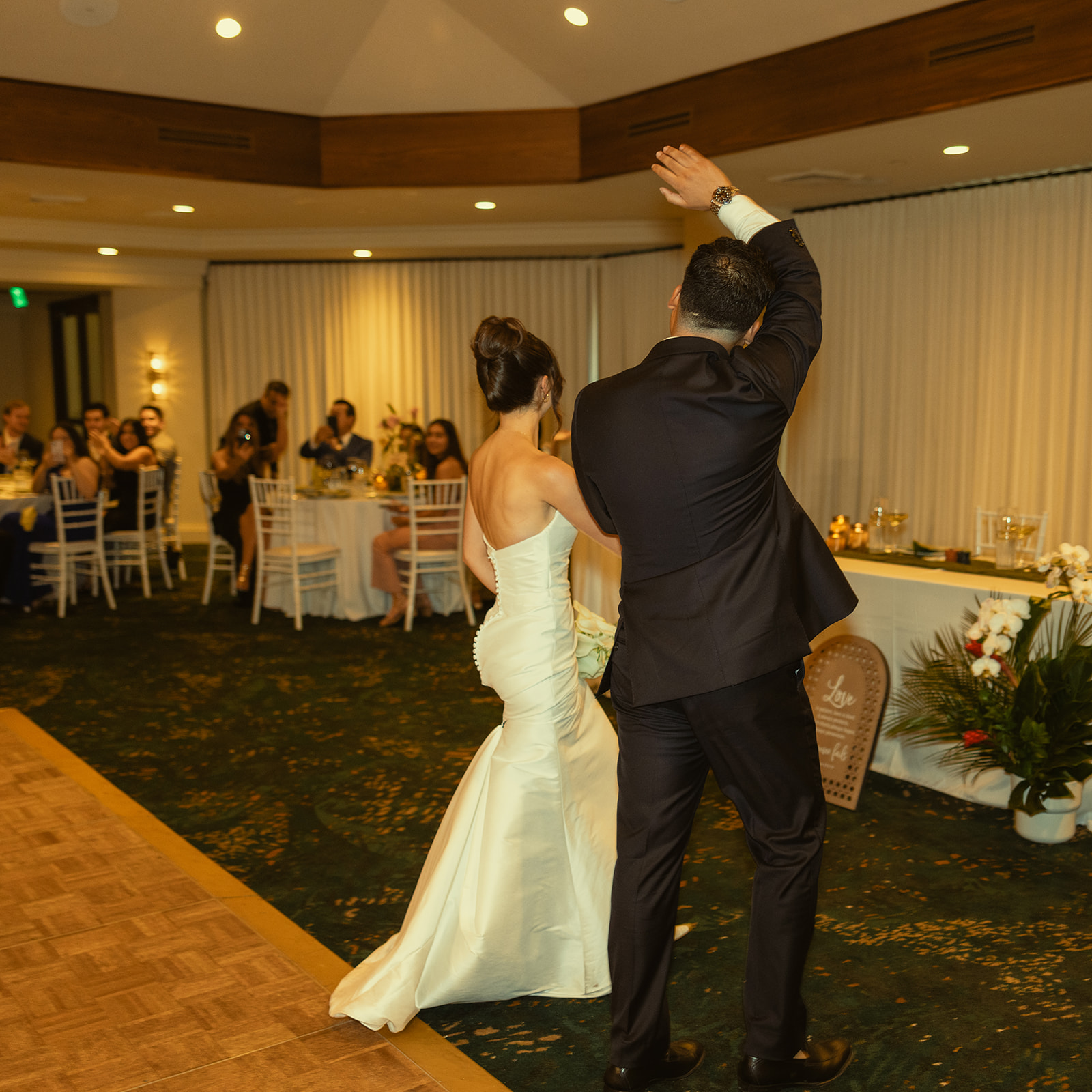 Reception Entrance Bride and Groom waving Photos Timeless Wedding in Mayfair Hotel & Garden