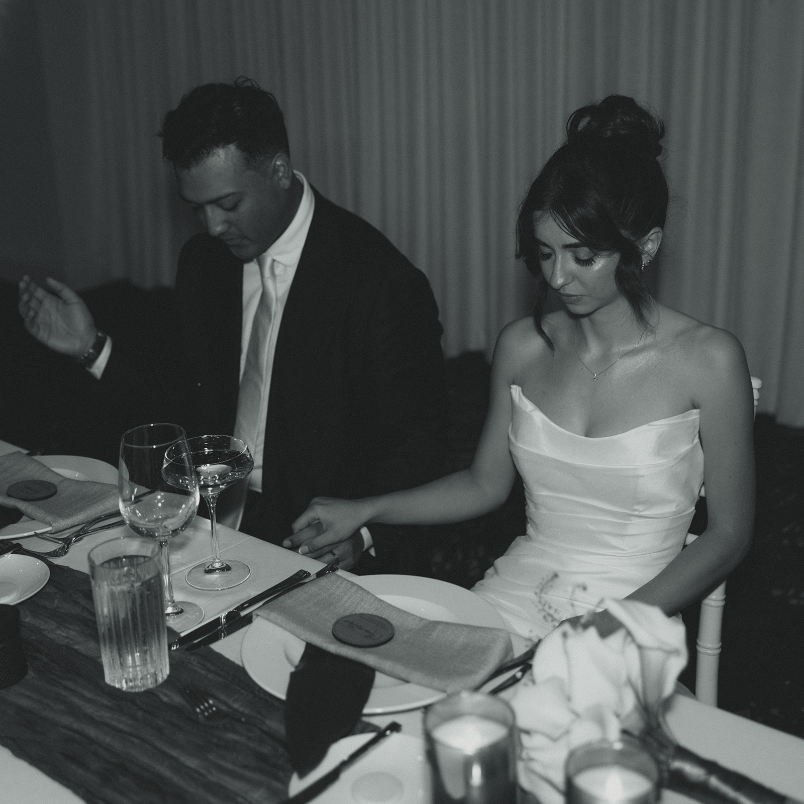 Bride and Groom Pray over food Reception Timeless Wedding in Mayfair Hotel & Garden