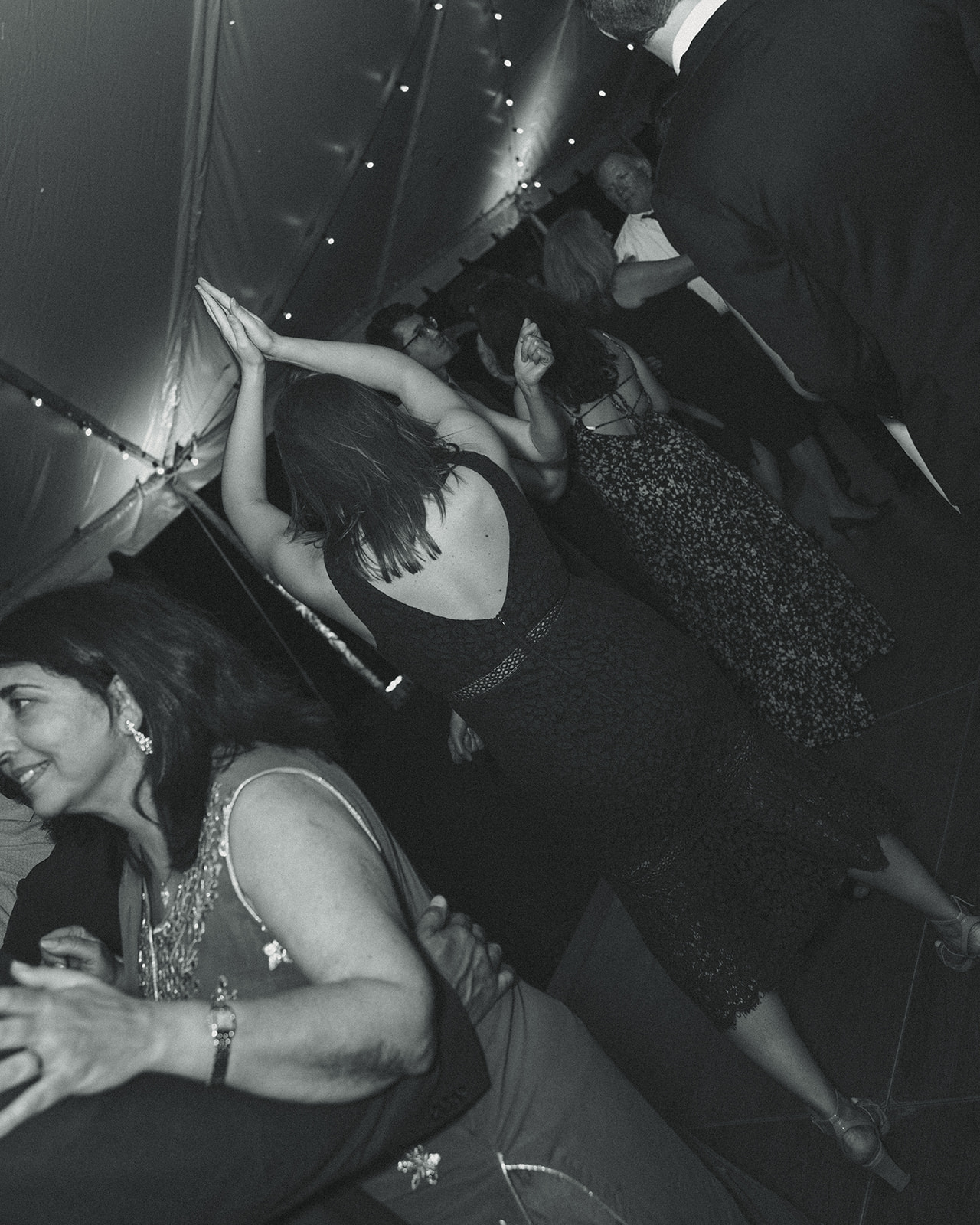 Guests Dancing candids during wedding reception. Wedding in West Florida, St Petersburg in Sunken Gardens in black and white