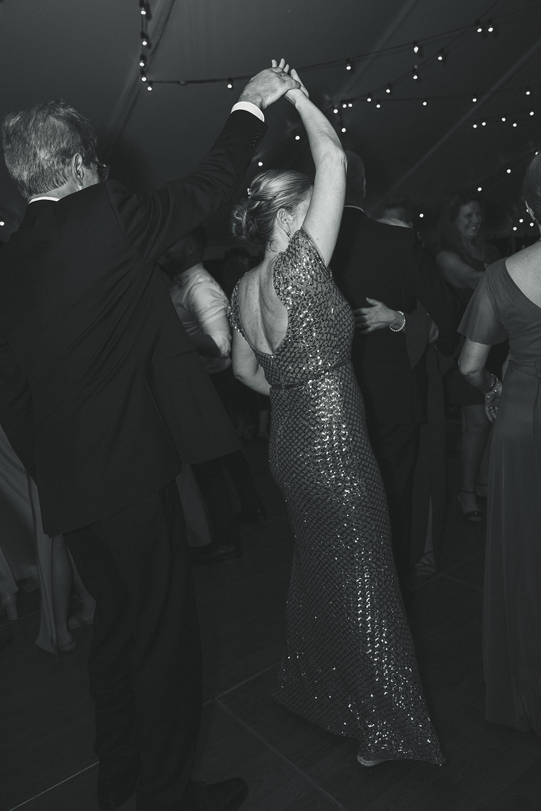 Guests twirling and dancing candids during wedding reception. Wedding in West Florida, St Petersburg in Sunken Gardens in black and white