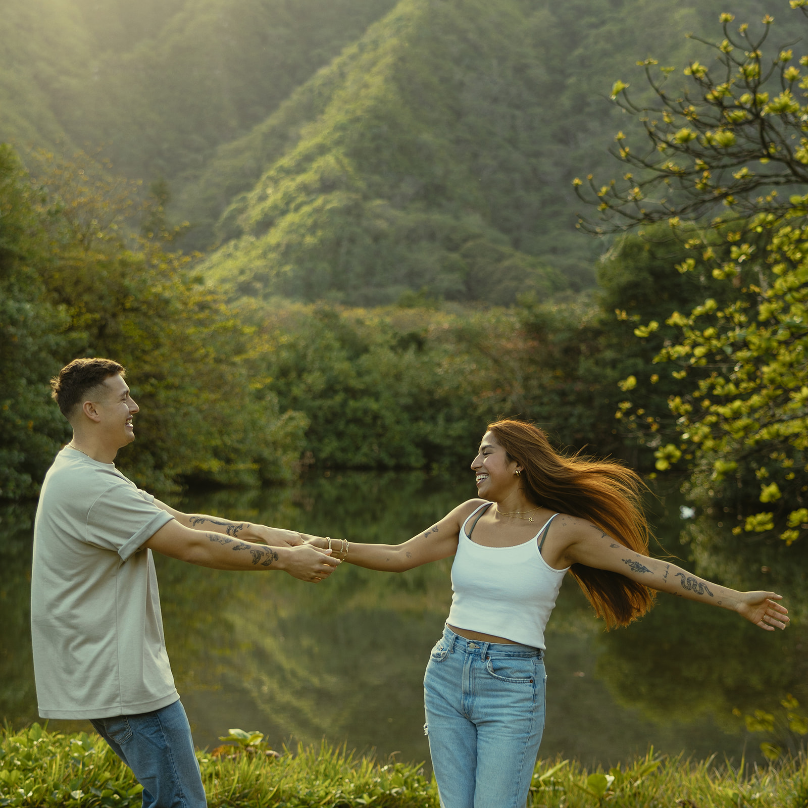 Lush Lakeside Mountains Oahu Hawaii Engagement Pictures Twirling Couple North Shore