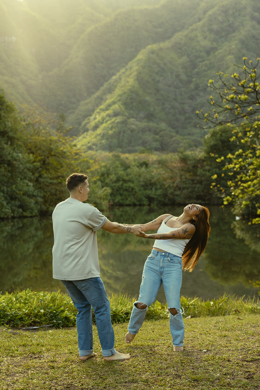 Lush Lakeside Mountains Oahu Hawaii Engagement Pictures Twirling Couple North Shore