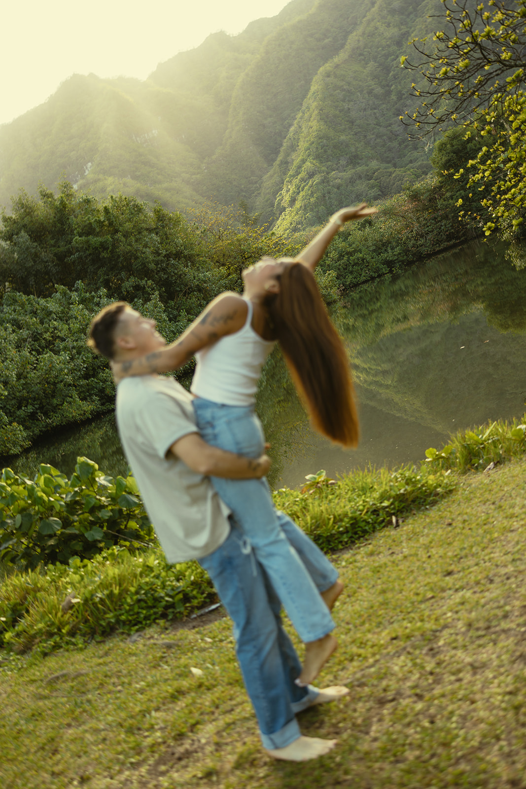 Lush Lakeside Mountains Oahu Hawaii Engagement Pictures Twirling and Dancing Couple North Shore