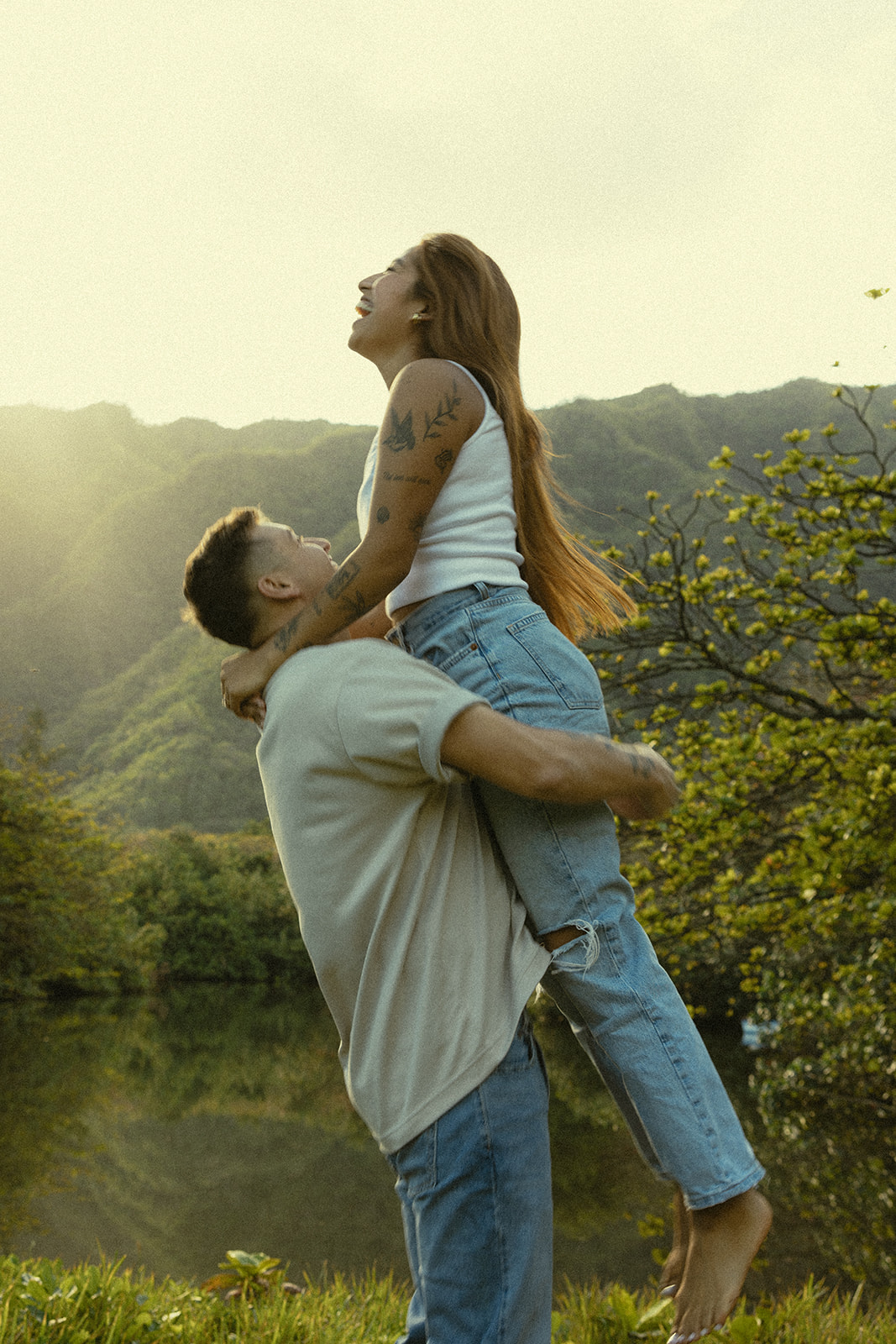 Lush Lakeside Mountains Oahu Hawaii Engagement Pictures Twirling and Dancing Couple North Shore